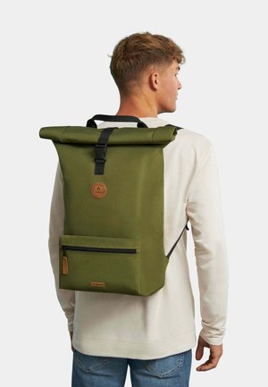 Green roll-top backpack made of durable fabric, featuring adjustable black straps, a front zipper pocket, and a circular logo patch.