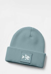 Blue ribbed beanie with a folded hem. Features a textured finish and a square patch displaying a white fish skeleton design.