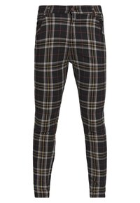 Pantaloni a quadri neri e grigi con accenti rossi e gialli, realizzati in un tessuto morbido, caratterizzati da una vestibilità slim e tasche anteriori.