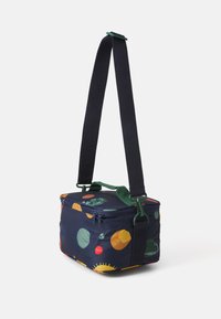 Rectangular fabric bag in navy with colorful circular patterns. Features green handles and a detachable strap. Zip closure on top.