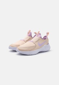 Light peach slip-on sneakers with purple accents, perforated upper, elastic straps, pull tabs, and a white rubber sole.