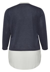 Długi rękaw t-shirt w granatowym kolorze z białym wykończeniem. Posiada okrągły dekolt oraz luźny krój z warstwowym designem.