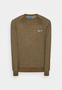 Bruine trui van textuurstof met een ronde hals. Heeft raglanmouwen en een wit geborduurd logo op de borst.