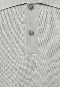 Gray polo shirt with a textured, knitted fabric. Features a buttoned placket with two metal buttons and a flat collar design.