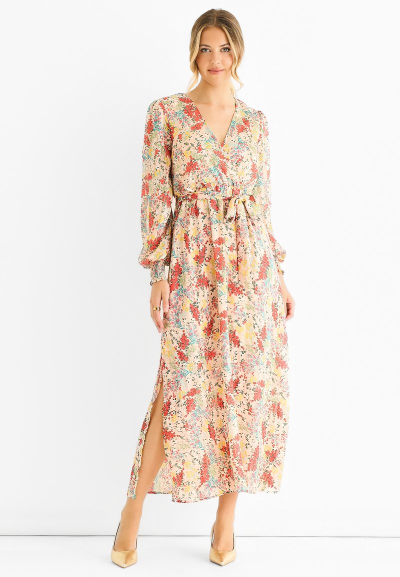 Floral maxi dress with a V-neckline, long puff sleeves, and a waist tie. Features a yellow-based fabric with red, blue, and green floral patterns.