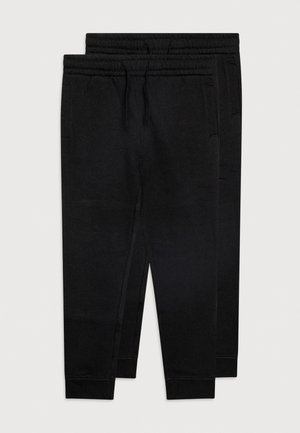 Pantaloni della tuta neri realizzati in tessuto morbido, con vita e polsini elasticizzati, tasche laterali e design a gamba affusolata.
