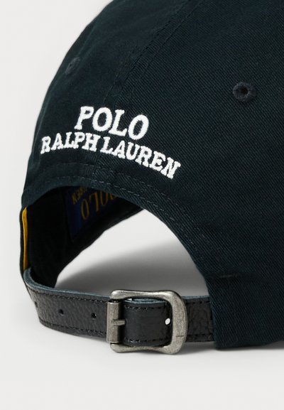 Black cotton cap with white embroidered "POLO RALPH LAUREN" on the front, leather strap and metal buckle closure at the back.