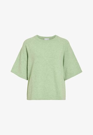 Šviesiai žalios spalvos per didelis trumpomis rankovėmis megztinis su apvalia kaklo iškirpte ir minkšta, faktūruota medžiaga. Turi raglano stiliaus rankoves ir trumpą ilgį.