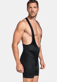 Schwarze Radsport-Bib-Shorts aus atmungsaktivem Material, mit einem strukturierten Design, ärmellosem Schnitt und figurschmeichelnder Silhouette.