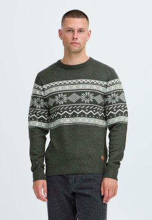 Green knit sweater with a round neck, featuring a white geometric and snowflake pattern across the chest and ribbed cuffs and hem.