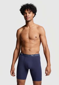 Navy blue boxer briefs with a snug fit, featuring a branded elastic waistband in gray with "PUMA" text. Soft fabric with a smooth texture.