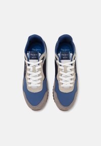 Blue and grey athletic shoes with suede and nylon materials, featuring white laces, a rubber sole, and branding on the tongue.