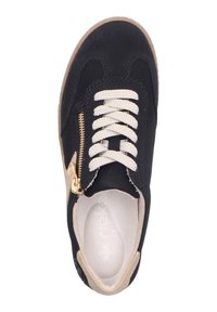 Black sneaker with textured upper, beige laces, gold zipper accent, and a tan rubber sole; features a cushioned insole for comfort.