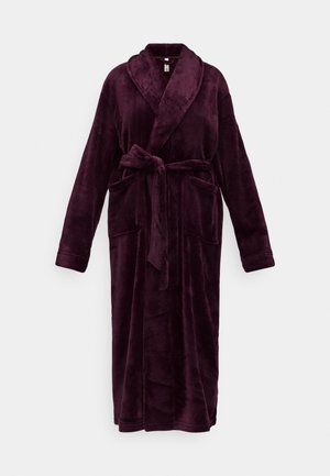 Long plush dark purple bathrobe with shawl collar, tied waist belt, and two front pockets, displayed against a white background.