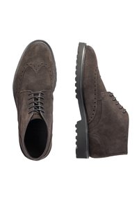 Brown suede brogue shoes with perforated detailing, round toe, and black rubber cleated sole. Features flat laces and a textured upper.