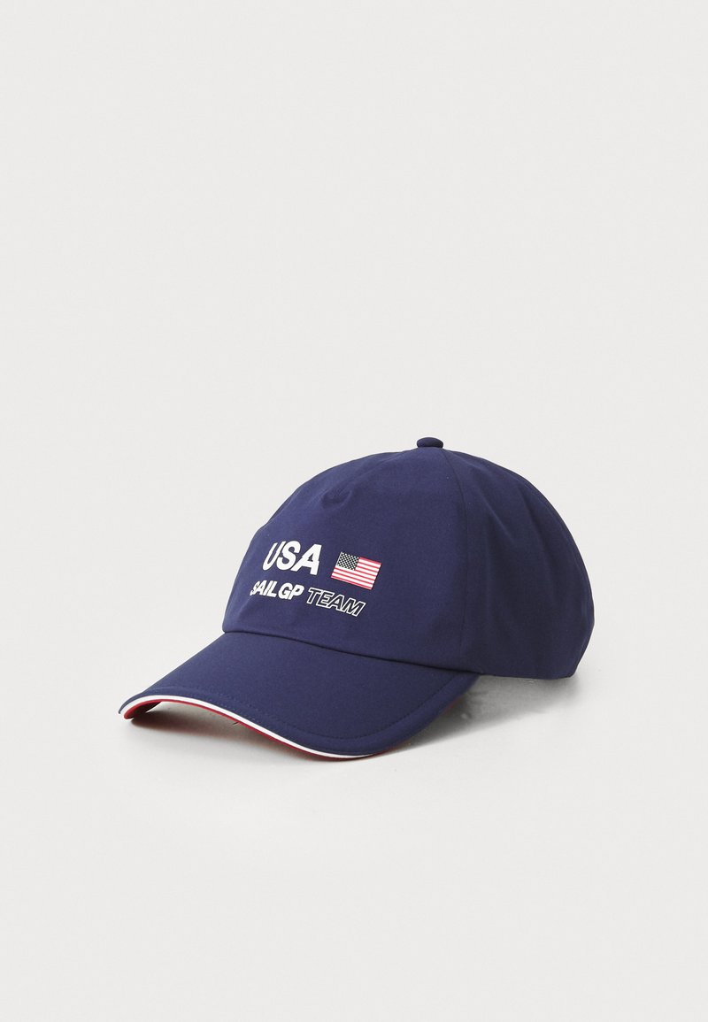 Marineblå baseballcap med "USA" og et lille flag, samt "SAIL GP TEAM" i hvid broderi og en rød- og hvid detalje på skyggen.