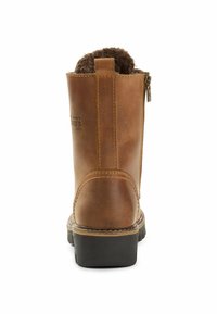 Braune Leder-Stiefelette mit flauschigem Kunstfellfutter, Reißverschluss an der Rückseite und robustem Gummisohle. Verziert mit Nahtnähten entlang der Kanten.