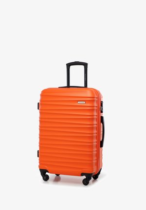 Valigia rigida arancione con design a righe verticali, manico nero estraibile e quattro ruote nere per una facile manovrabilità.