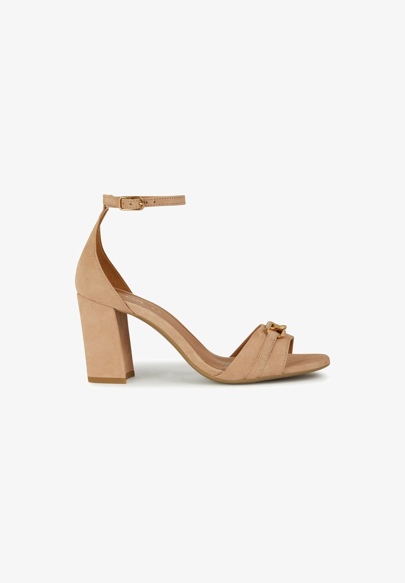 Sandale à talon bloc en daim beige avec bride à la cheville, bout ouvert et boucle dorée décorative sur la bride avant.