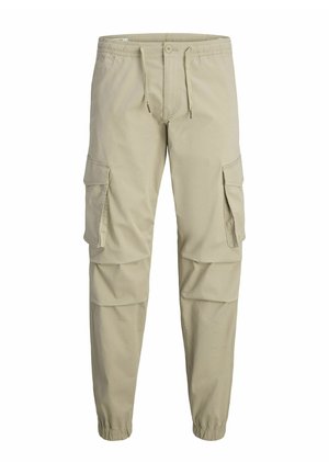 Beige cargo pants with an elastic waistband, drawstring, two large side pockets, and elastic cuffs at the ankles. Made of soft fabric.