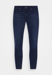 Jeans skinny de denim oscuro con diseño de cinco bolsillos, que cuentan con un cierre de botón y cremallera, y costuras en contraste. Textura suave.