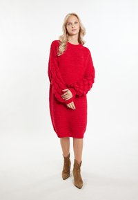 Abito maglione rosso lavorato a maglia con texture a costine, maniche oversize con motivo a bolle e scollatura rotonda. Rifinito con un bordo orlato.