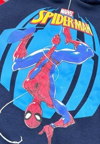 Haut à capuche bleu marine avec une illustration de Spider-Man en rouge et bleu, détaillé avec des motifs de toile d'araignée et un logo Marvel au-dessus.