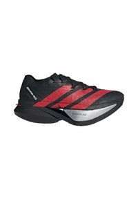 Black and red running shoe with a textured upper, three red stripes, and a silver midsole labeled "LIGHTSTRIKE PRO." Sleek and aerodynamic design.