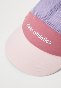 Cap with a pink and lavender design; features a textured polyester brim, mesh panel, and "ciele athletics" logo in white.