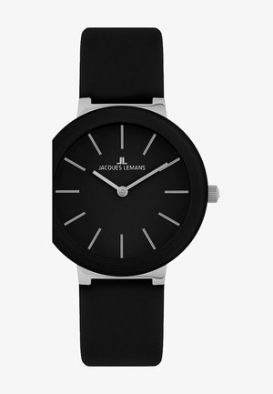 Montre avec bracelet en silicone noir, cadran noir mat, marqueurs d'heure argentés et un design minimaliste. Elle possède une couronne argentée sur le côté.