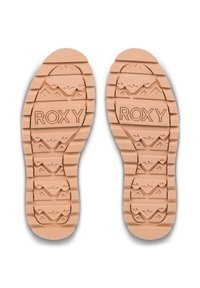 Semelles de chaussures Roxy en caoutchouc beige clair, avec des motifs texturés, un motif de montagne et le nom de la marque en relief pour une meilleure adhérence.