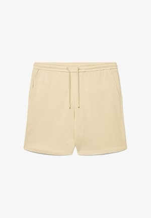 Pantaloncini beige in cotone con cintura elastica, coulisse e tasche laterali, progettati per un uso casual.