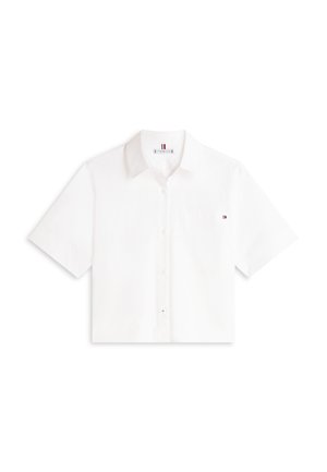 Λευκό πουκάμισο με κοντά μανίκια, κουμπιά μπροστά, γιακά, μια μικρή τσέπη στο αριστερό στήθος και ένα μικρό λογότυπο της σημαίας στο αριστερό μανίκι.