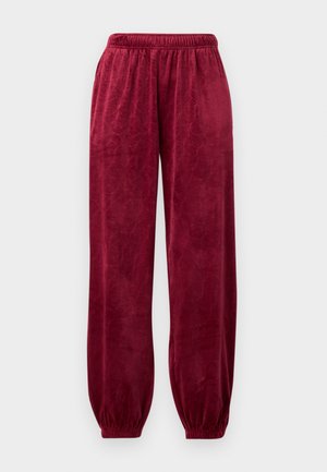 Pantaloni della tuta in velluto rosso con cintura elastica, polsini affusolati e un sottile motivo geometrico su tutto il tessuto.