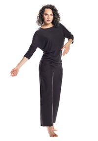Black relaxed-fit top with wide neckline and three-quarter sleeves, paired with matching loose-fit trousers, both made from soft fabric.