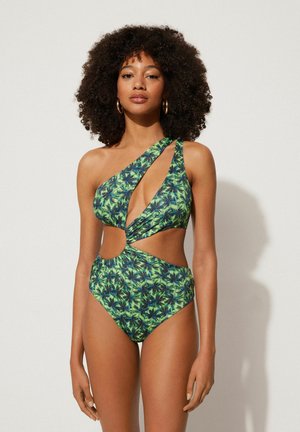 Maillot de bain une pièce avec un motif de feuilles de palmier vertes et bleues, découpe asymétrique avec une échancrure sur le côté, et une texture lisse et soyeuse.