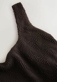 Brown textured top with a ribbed design and wide straps. Features a wave-like pattern across the surface, showcasing a unique fabric texture.