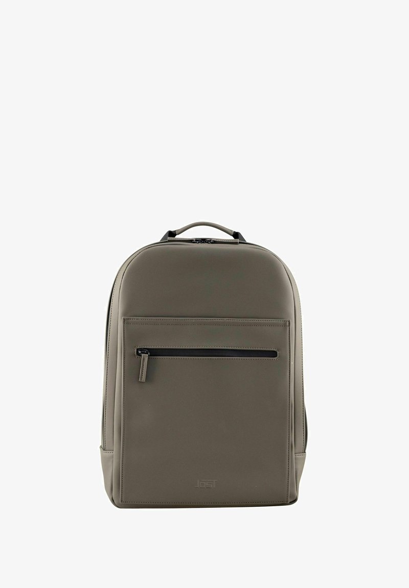 Sac à dos synthétique gris avec une texture lisse, poche avant zippée et une poignée supérieure. Présente un design minimaliste avec des bords arrondis.
