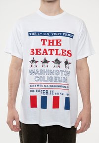 White cotton t-shirt featuring bold red and blue graphic text about The Beatles’ 1964 concert at Washington Coliseum, with star accents.