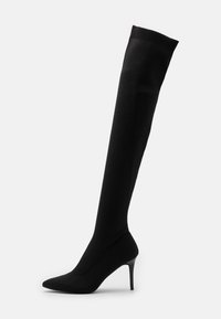 Černé černé nadkolenní ponožkové boty s elegantním designem, špičatou špičkou a jehlovým podpatkem. Vyrobené z texturované pleteniny s žebrovaným horním okrajem.