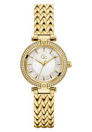 Gold wristwatch with a woven strap, round case, and crystal bezel. White dial features gold hands and markers, with a textured design.