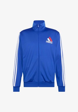 Blue zip-up sports jacket with white stripes on sleeves, small France logo in red, white, and blue on left chest.