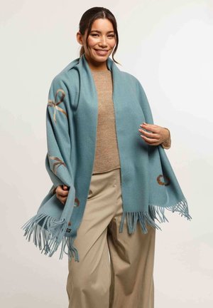 Sciarpa azzurro chiaro realizzata in materiale morbido, con bordi frangiati e motivi decorativi marroni che ricordano fiocchi su entrambi i lati.