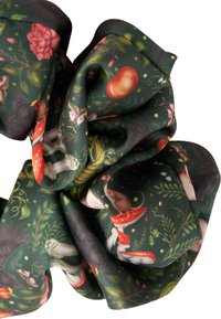 Fabric scrunchie featuring a dark green background with floral and woodland animal prints, including mushrooms, roses, and leaves.