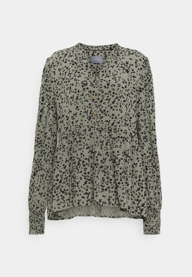 Blusa verde con motivo a pois neri, con bottoni sul davanti, maniche lunghe con polsini arricciati e design a strati e svasato. Tessuto morbido.