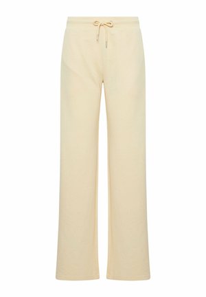 Beżowe szerokie spodnie dresowe z elastycznym pasem i sznurkiem, pokazane na płasko na białym tle.