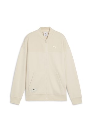 Giacca Puma beige con zip frontale, tessuto testurizzato, colletto e polsini a coste, due tasche frontali e logo Puma sul petto e sull'etichetta della tasca.