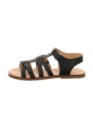 Sandalo aperto in pelle nera con più cinturini, soletta imbottita beige e cinturino alla caviglia in Velcro su suola piatta marrone.