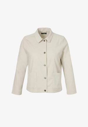 Veste en velours côtelé de couleur crème avec cinq boutons métalliques, deux poches avant, des manches longues et un col pointu.