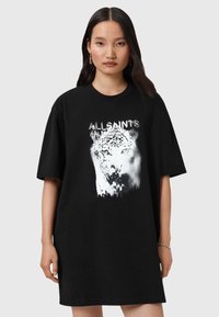 Camiseta negra de gran tamaño hecha de algodón, con un gráfico de un leopardo blanco y el texto "ALLSAINT'S" en un estilo desgastado.